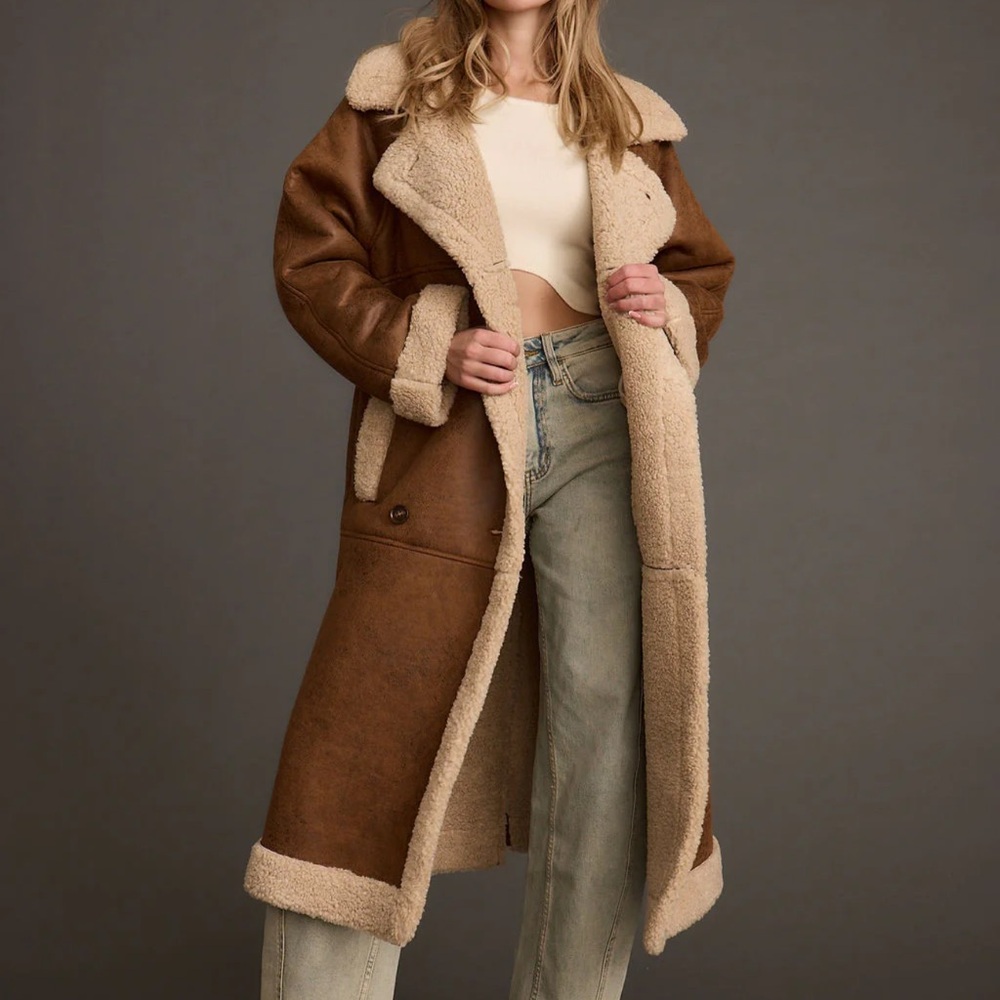 Sherpa lining and accents. Pockets on each side. Will fit 8-14 sizing